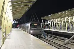 M2 train approaching Haliç platform at night.