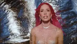 Halsey looking at the camera wearing a pink wig and a crystal bodysuit