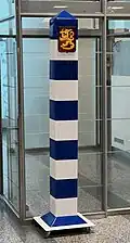 Symbolic Finnish border marker on casters in the immigration hall of Helsinki-Vantaa Airport.