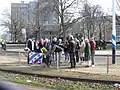 Family and friends attach flowers for a Frisian victim to the tram track fence