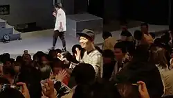 Tanaka appeared from audience seats and then came up on stage.