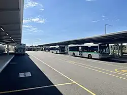 Road with bus stops and canopy shelter along the sides