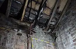 A photo of the underside of the roof with rotten timbers
