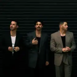 The three brothers wearing coats front of a black wall