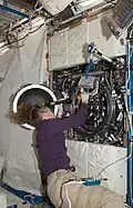 Sandra Magnus as she works with the Combustion Integrated Rack (CIR) in the U.S. Laboratory, Destiny, during maintenance.