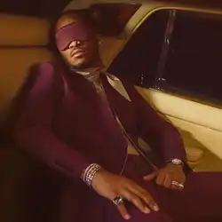 Future lounging in the backseat of a car with a sleep mask over his eyes