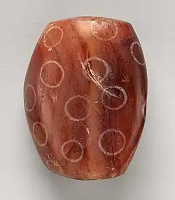 Indus Civilisation Carnelian bead with white design, ca. 2900–2350 BCE. Found in Nippur, Mesopotamian.[86]