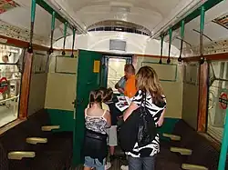 An old-fashioned London Underground train with hanging straps without looped handles