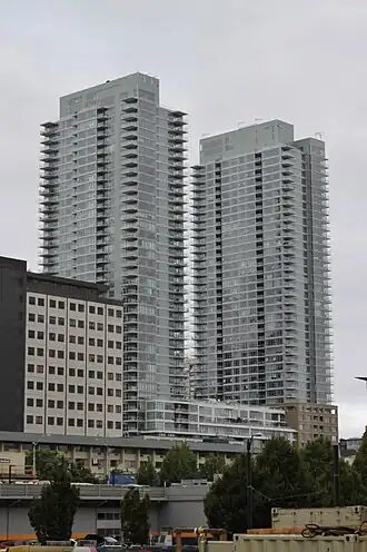 Two high-rise buildings with protruding balconies seen from a distance
