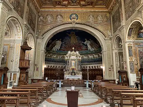 Nave of the basilica facing the apse, high altar, reredos, and choir.