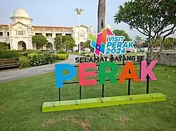 Front facade of the Ipoh Railway Station with the Perak Tourism signage.