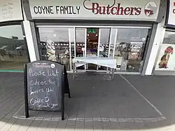 Irish butcher implementing ad hoc social distancing measures.