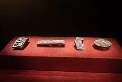 A complete set of Jade Sword Ornaments from left to right: pommel, guard, slide and chape.