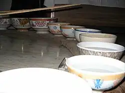 row of bowls, mostly filled with water
