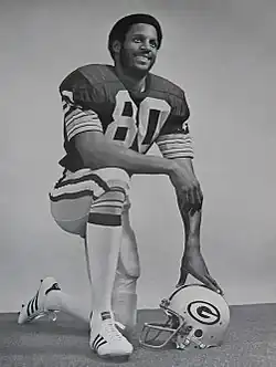 Lofton kneeling in his uniform