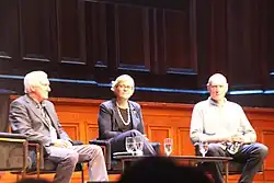 Steggall (centre) on a stage with John Hewson (left) and Peter Garrett (right)