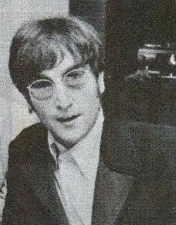 A head and shoulders picture of John Lennon, wearing sunglasses
