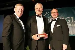 In 2010, the Georgia Historical Society and the Office of the Governor of Georgia inducted Ted Turner as a Georgia Trustee. Turner is pictured here at the induction ceremony in Savannah with U.S. senator Johnny Isakson (left) and Georgia Historical Society president Todd Groce (right).