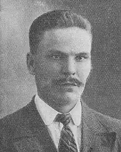 a black and white photo of this person. he has a mustache