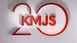An image with a white background. The text "KMJS" is displayed on the center of the image, over the number 20.