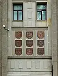 A cartouche with the voivodeship coat of arms on the east side of the building.