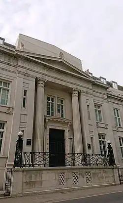 Photograph of a building in grey stone with columns.