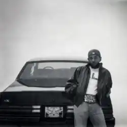 A black-and-white vignetted photo of Lamar leaning against the back of the titular GNX
