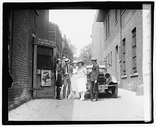Several patrons and a flapper await the opening of the Krazy Kat Klub, a speakeasy in Washington, D.C., in 1921.
