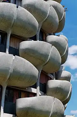 The curved balconies in front of each apartment's windows