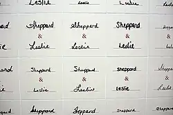 Ceramic tiles with the words "Sheppard & Leslie" painted on