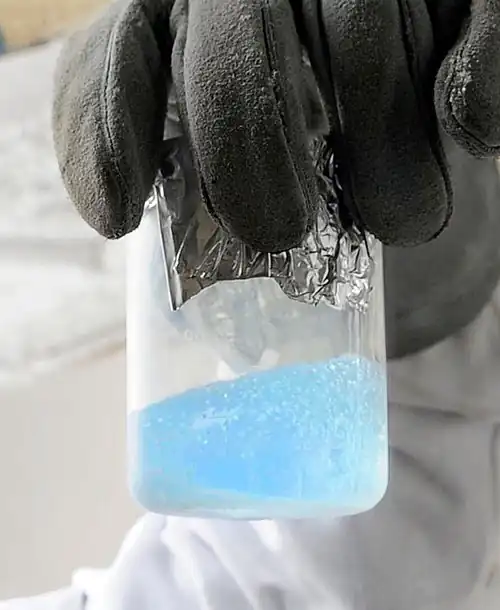A pale blue liquid, with visible boiling