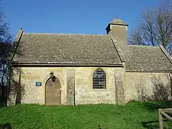 A very small church seen from the south, with the nave on the left, a smaller chapel to the right, and at the west end of the chancel, a bellcote