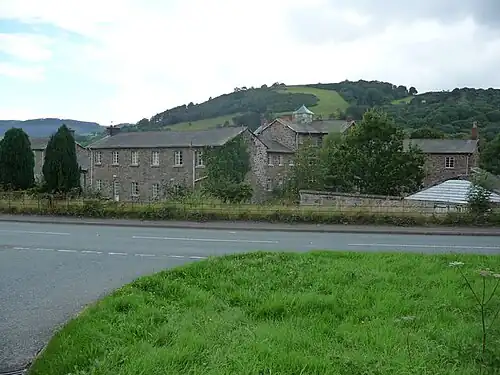 Buildings originally built as Llanfyllin workhouse, a state-funded home for the destitute which operated from 1838 to 1930.[95][96]