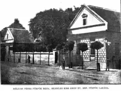 A small house in a street.