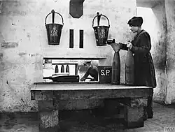 Fire buckets at a British munitions plant during World War I, marked with the royal cypher of George V