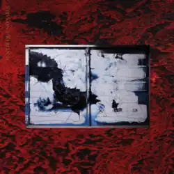 A broken metallic object in the center of a red and black patterned background.