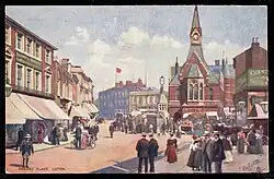 A postcard showing a streetscene of George Street looking South East towards Market Hill in the early 20th Century.