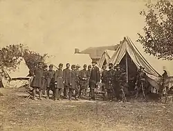 Lincoln among a group of soldiers in a military camp