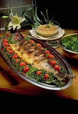 Image 17Masghouf fish, one of Iraq's national dishes, a Mesopotamian cuisine dating back to ancient times, typically fish caught from the rivers of Euphrates and Tigris, and grilled near the river bed (from Culture of Iraq)