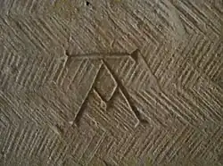 Mason's mark in the Église Saint-Honorat [fr] in Alyscamps, France, early 13th century
