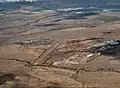 Aerial view, from the south, of Puʻunēnē with the old airstrip that is now the dragstrip at Maui Raceway Park
