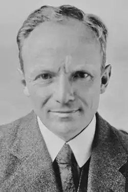 Sepia photograph of man in gray or beige woolen suit