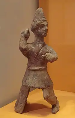 Mingqi (Chinese funerary statuette) of a young Central Asian man, with Saka-type caftan and conical hat reminiscent of early 3rd century AD Kushans. Later Han, 3rd century AD. Guimet Museum (MA 4660).[240]