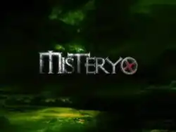 An image with black clouds over a green background. The show title is displayed on the center of the image.