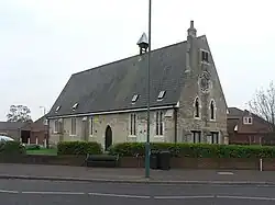 The old school at Moordown, licensed for church services, built to the design of G. E. Street in 1853 and later used as a builders' merchants' office. It has now been converted into housing.