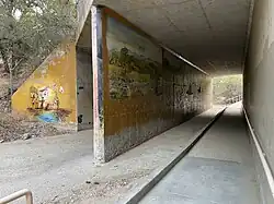 A mural depicting the valley's diverse history (left), Tataviam life prior to European settlement (center), and the discovery of gold by Francisco Lopez (not pictured)