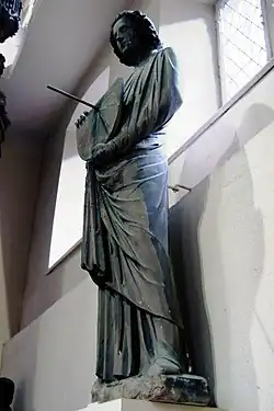 Sculpture of a man holding a functioning tide dial