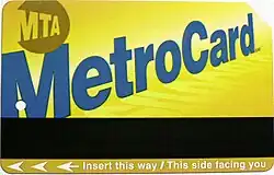 a yellow rectangle metro transit card with a black strip and has the words "MTA" and "Metro Card" on it