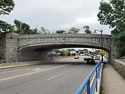 An arched concrete bridge over a city street