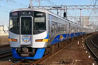 A photo of a Nankai 12000 series train in motion